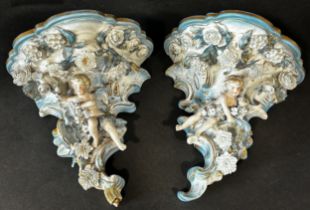 Pair of 19th century porcelain German ceramic brackets, floral encrusted and with cherub supports