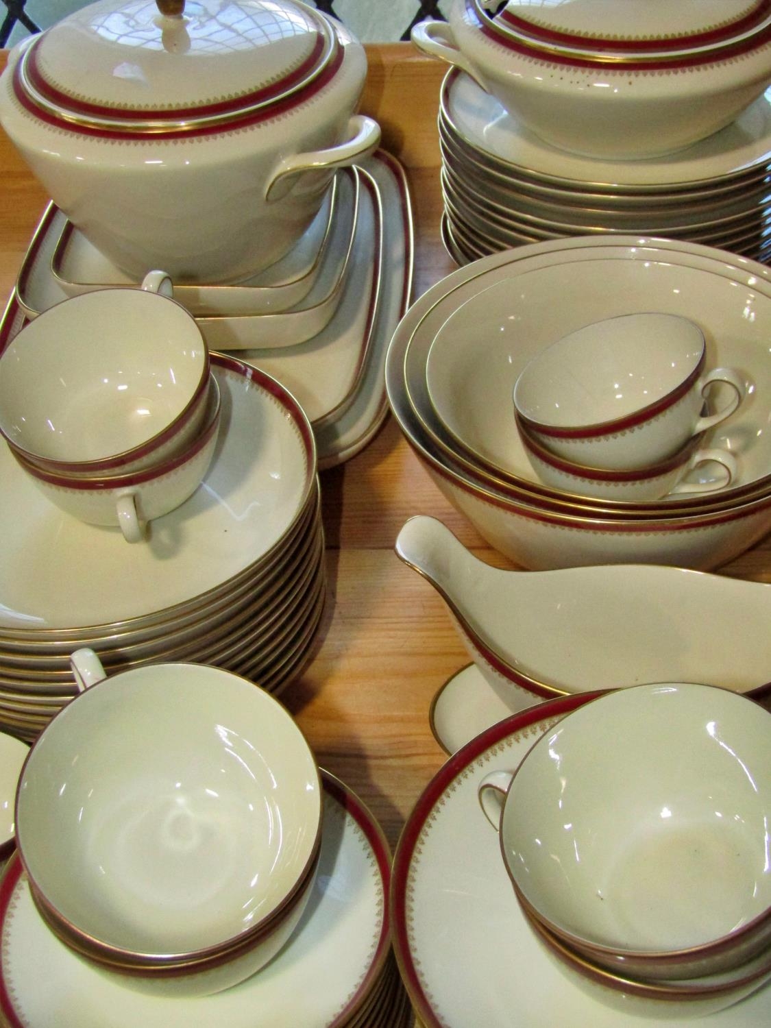 A Langenthal porcelain dinner service with oxblood and gilt banded borders comprising dinner plates, - Image 4 of 5