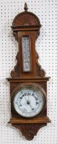 An Edwardian oak cased aneroid barometer