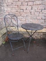 a heavy gauge decorative folding iron garden table, 60cm diameter and folding chair with open