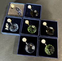 A collection of seven Swarovski crystal wall hanging decorations in various colours and patterns