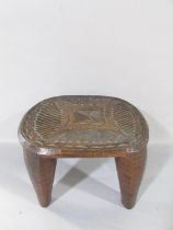 Small African hardwood Nupe stool with geometric carved detail top set on four circular tapering