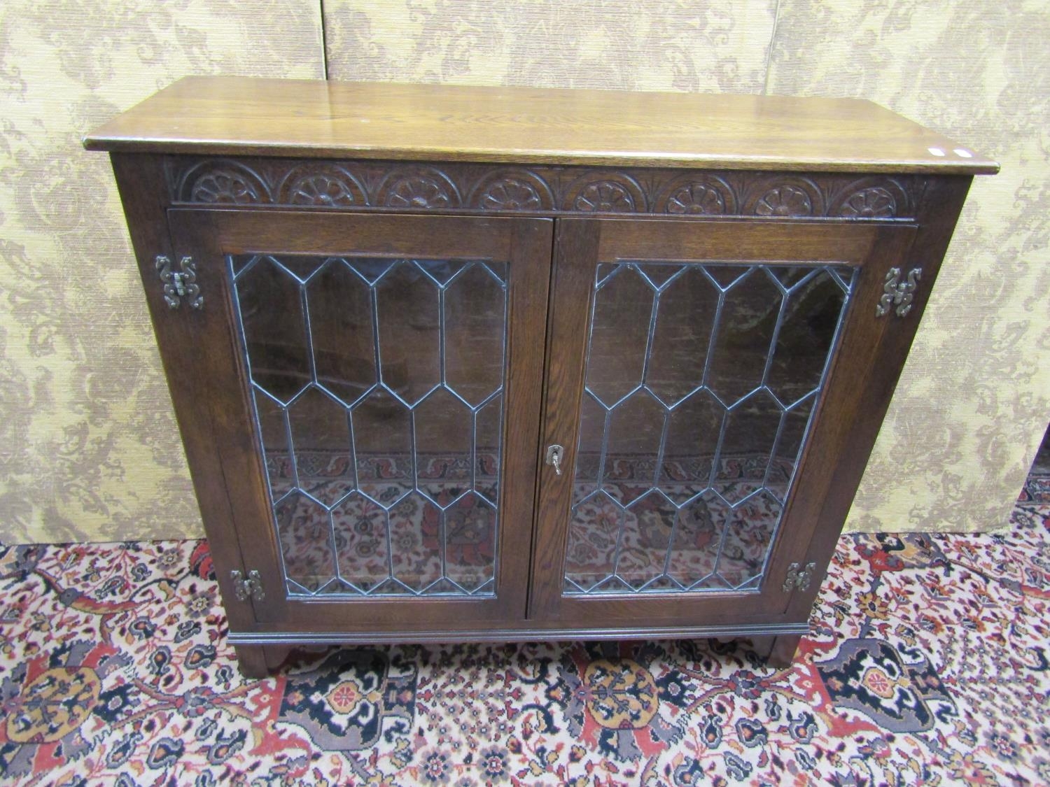 A glass-fronted cabinet, twin door with key
