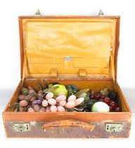 A distressed leather Finnagans attaché case containing some Chinese hardstone fruits, grapes, lemon,