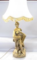 A figural table lamp of “Liberté” holding a laurel, in a gold finish, indistinctly signed,