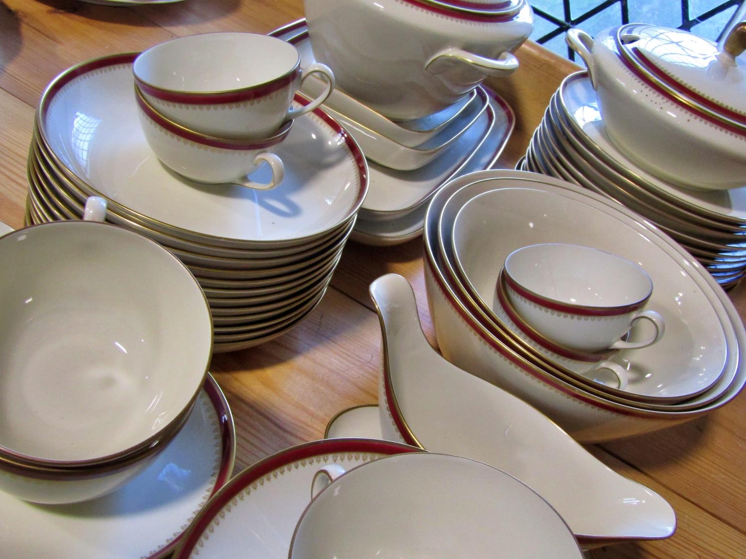 A Langenthal porcelain dinner service with oxblood and gilt banded borders comprising dinner plates, - Image 2 of 5