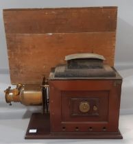 A Victorian Magic lantern projector in mahogany with brass mounts, large glass lens and tin