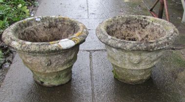 Pair of weathered cast composition stone garden planters of circular tapered form, with repeating