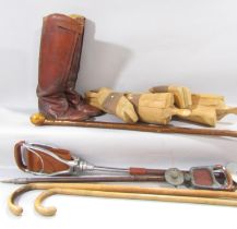 A pair of vintage brown leather riding boots, a pair of wooden shoe trees, two shooting sticks,