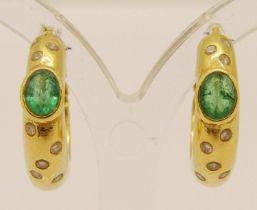 Pair of yellow metal hoop earrings set with oval emeralds and round diamonds, 7.9g