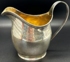 Georgian silver cream jug with floral engraving and loop handle, London 1807, makers mark rubbed,
