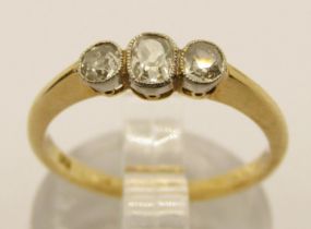 Early 20th century 18ct three stone old-cut diamond ring with millegrain setting, outer pair of