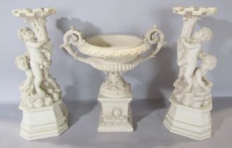 A classical decorative Renaissance style urn on a classical base, flanked by putti holding aloft