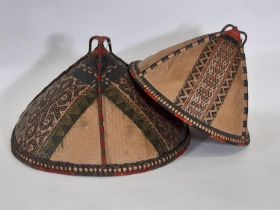 Two early 20th century traditional woven hats from Borneo, both of rattan, finely woven into