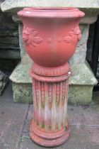 French terracotta urn with lions mask detail raised on a fluted cylindrical pedestal, 34cm