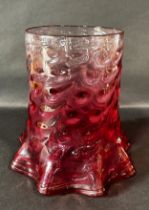 A 19th century cranberry crimped and dimpled glass oil lamp shade.23cm high.