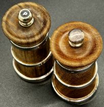 A pair of hard wood turned millennium salt and pepper mills with silver banding, (pepper with