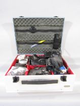 A Rox Metal Hard Case for camera equipment with a padded sponge interior containing a Tamron 75-