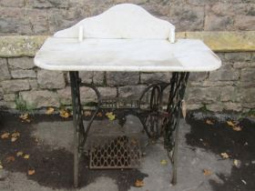 Vintage cast iron Singer sewing machine base, later adapted as a garden table or wash stand with