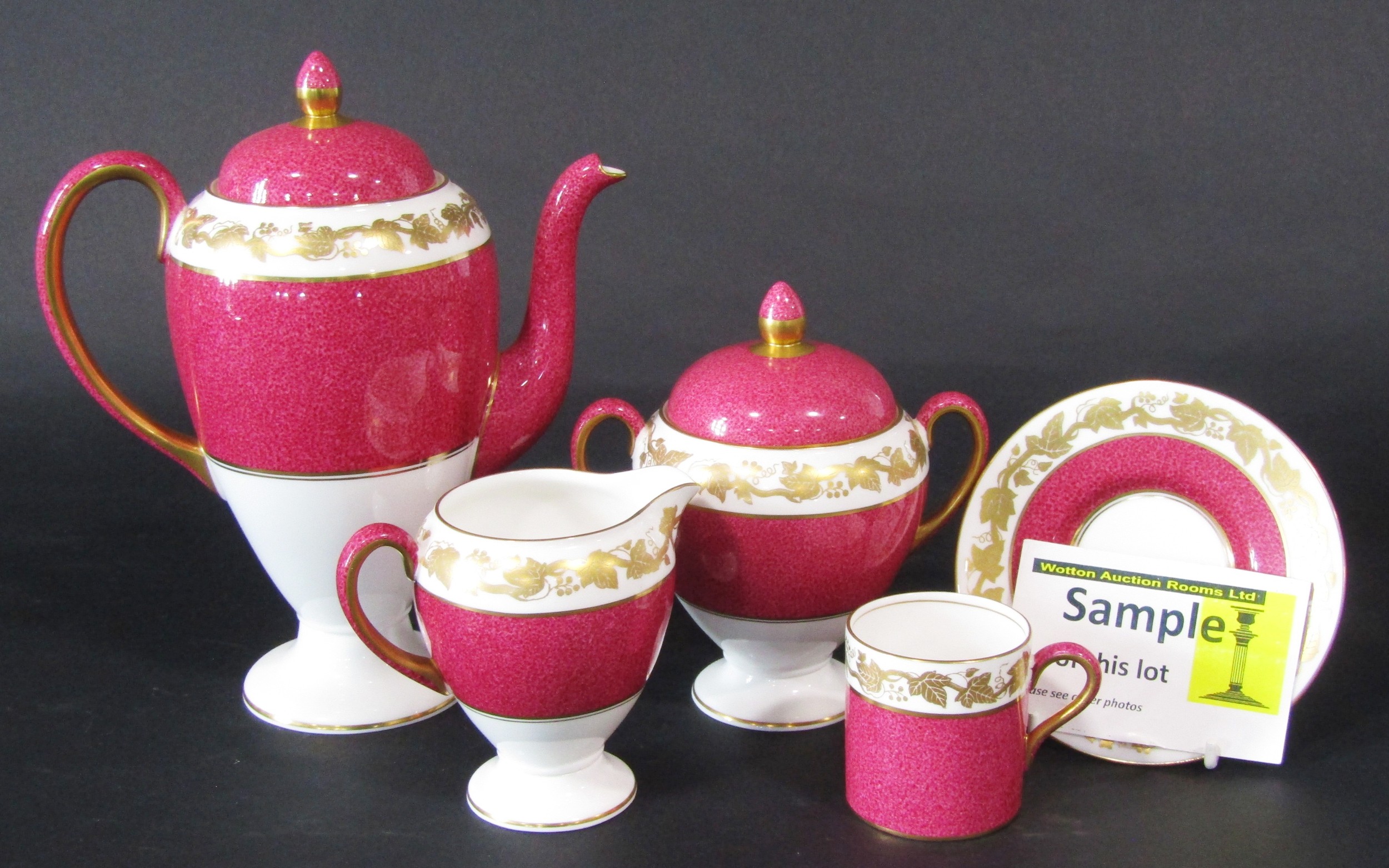 Wedgwood coffee set in raspberry pink and gilt colourway to include 6 coffee cans & saucers,