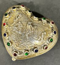 A silver heart shaped trinket box with a wine harvest scene to the centre surrounded by multi