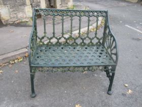 A green painted heavy gauge cast alloy two seat garden bench with Gothic tracery detail, 87cm wide