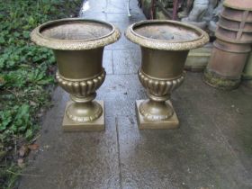 Pair of over painted composite urns with flared repeating pattern rims, lobed bowls and square