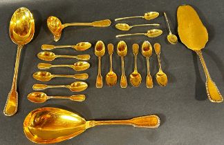A large quantity of loose unmarked beaded gold coloured cutlery, and oval silver plated Bain