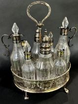 Georgian silver cruet stand with filigree oval sides, accommodating eight bottles (various),