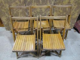 Set of five folding stained beechwood chairs with slatted seats