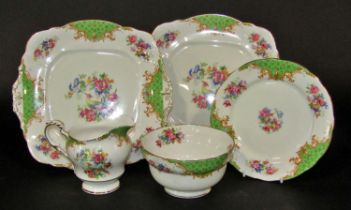 A Paragon Rockingham pattern tea set for 12, with exotic birds and bouquet detail within a green and
