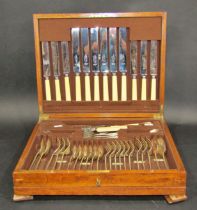 An oak canteen of Viner's cutlery for six settings, forks, spoons, teaspoons in silver, knives