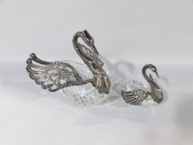 A mother swan glass salt cellar with articulated silver wings and neck, together with her cygnet