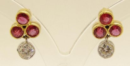 Pair of 18ct ruby trefoil and diamond drop earrings with millegrain setting, the diamonds 0.15ct