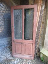 An old French wooden farmhouse door with glazed openings and iron work panels, 91cm wide x 200cm hig