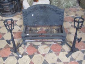 An Arts and crafts style cast iron fire basket and combined dogs the arched back plate with raised