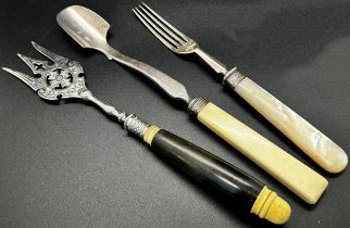 Silverware including mother of pearl handled forks, a pair of napkin rings, two silver sugar