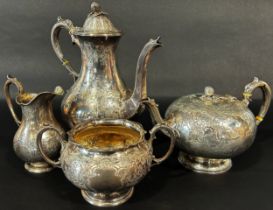 A four piece Victorian silver tea service, tea and coffee pots, milk jug and sugar bowl, heavily