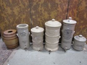 A collection of five leadless glazed cylindrical water filters comprising Doulton's Improved Germ