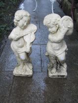 Two painted cast composition stone ornaments in the form of cherub musicians, slight variation in