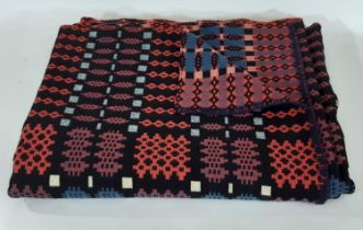 Traditional woollen welsh blanket in reversible double weave, in red, blue, black and white colours,