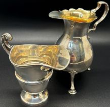 A 19th century silver gilt cream jug, raised on three pad feet, Chester 1894, maker James Deakin &