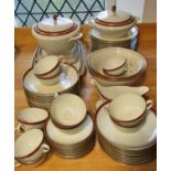 A Langenthal porcelain dinner service with oxblood and gilt banded borders comprising dinner plates,