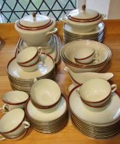 A Langenthal porcelain dinner service with oxblood and gilt banded borders comprising dinner plates,