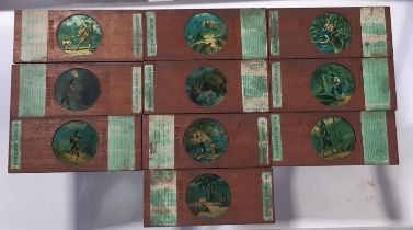 10 Victorian coloured magic lantern slides, Robinson Crusoe, circular in mahogany casework with