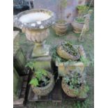 A weathered cast composition stone garden urn the circular lobed bowl with egg and dart flared rim