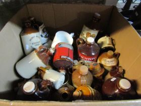 Box containing a collection of small stoneware cider jugs/jars, with printed and applied merchants