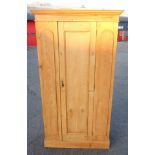 Victorian pine wardrobe with a moulded cornice and panelled door, on a plinth base, 198.5 x 111 x