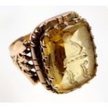 Yellow metal signet ring with decorative pierced borders, set rectangular citrine with engraved