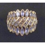 Foreign 9ct gold ring with lavender blue stones in a zig-zig openwork setting, convention marks by I